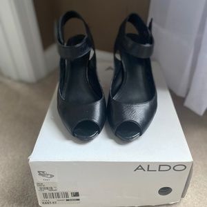 Black dress shoe with wooden heel and ankle strap